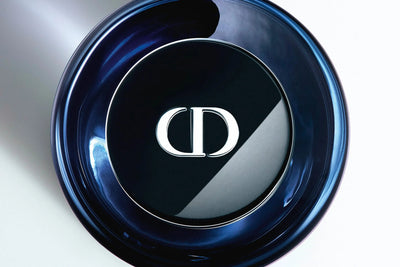 Close-up of a Dior sauvage elixir bottle with the brand logo.